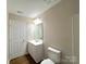A well-lit bathroom features a sleek vanity, contemporary mirror, and efficient toilet at 7147 Henderson Valley Ln, Charlotte, NC 28269