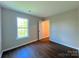 Bedroom with hardwood floors, neutral walls, and natural light at 7147 Henderson Valley Ln, Charlotte, NC 28269