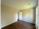 Bedroom with hardwood flooring, closet, natural light, and neutral paint at 7147 Henderson Valley Ln, Charlotte, NC 28269