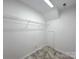 Walk-in closet with neutral paint, gray floors, and metal shelving at 7147 Henderson Valley Ln, Charlotte, NC 28269