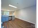 Open concept kitchen with modern countertops, appliances, and wood flooring at 7147 Henderson Valley Ln, Charlotte, NC 28269
