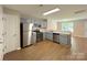 Stylish kitchen with stainless appliances and ample cabinet space and view into living area at 7147 Henderson Valley Ln, Charlotte, NC 28269