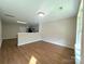 Bright and airy living room showcasing sleek wood floors and neutral walls at 7147 Henderson Valley Ln, Charlotte, NC 28269
