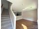 Open-concept living area featuring wood floors and seamless flow into the kitchen at 7147 Henderson Valley Ln, Charlotte, NC 28269