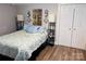 Cozy bedroom featuring a queen-size bed, wood floors, and white closet doors at 806 Grace St, Kings Mountain, NC 28086