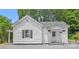 Charming white home featuring a cozy front porch with hanging flower baskets at 806 Grace St, Kings Mountain, NC 28086