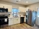 A bright and modern kitchen with white cabinets and stainless steel appliances at 806 Grace St, Kings Mountain, NC 28086