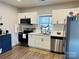 Modern kitchen featuring white cabinets, stainless steel appliances, and hardwood floors at 806 Grace St, Kings Mountain, NC 28086