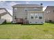 A wide shot of the house's backyard featuring a wooden deck and a grass lawn at 848 Wingthorn Rose Dr, Gastonia, NC 28056