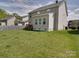 Fenced backyard featuring lush green grass and a wooden deck, ideal for recreation at 848 Wingthorn Rose Dr, Gastonia, NC 28056
