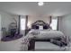A spacious main bedroom featuring a chair, rug, tray ceilings, neutral walls, and carpet flooring at 848 Wingthorn Rose Dr, Gastonia, NC 28056
