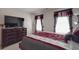 Comfortable bedroom features well-dressed bed, two windows, and a television at 848 Wingthorn Rose Dr, Gastonia, NC 28056