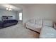 Carpeted bedroom with a sofa and window providing natural light at 848 Wingthorn Rose Dr, Gastonia, NC 28056