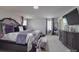 A spacious main bedroom featuring tray ceilings, neutral walls, carpet flooring, and great natural light at 848 Wingthorn Rose Dr, Gastonia, NC 28056