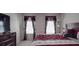 Comfortable bedroom features well-dressed bed, two windows, and a television at 848 Wingthorn Rose Dr, Gastonia, NC 28056