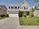 Charming two-story home with a manicured lawn and a spacious two-car garage at 848 Wingthorn Rose Dr, Gastonia, NC 28056