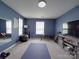 Home gym featuring an exercise mat, weights, and mirrors at 848 Wingthorn Rose Dr, Gastonia, NC 28056