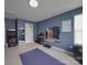 Home gym featuring an exercise mat, weights, mirrors and an arcade game at 848 Wingthorn Rose Dr, Gastonia, NC 28056