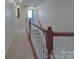 A neutral-toned hallway featuring white railings and neutral colored carpet at 848 Wingthorn Rose Dr, Gastonia, NC 28056