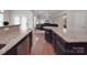 Spacious kitchen with a granite countertop island overlooking an open living area at 848 Wingthorn Rose Dr, Gastonia, NC 28056
