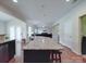 Open-concept kitchen and living room with an island featuring granite countertops at 848 Wingthorn Rose Dr, Gastonia, NC 28056
