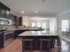 Well-equipped kitchen featuring dark cabinets and a granite-topped island with barstool seating at 848 Wingthorn Rose Dr, Gastonia, NC 28056