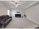 Expansive living area with plush carpeting, a ceiling fan, and natural light at 848 Wingthorn Rose Dr, Gastonia, NC 28056