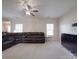 Large living room with an open concept, plush carpet, and contemporary ceiling fan at 848 Wingthorn Rose Dr, Gastonia, NC 28056