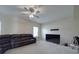 Spacious carpeted living room with ceiling fan, media connections and comfortable seating at 848 Wingthorn Rose Dr, Gastonia, NC 28056
