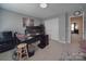Office area with a dark desk, two computer screens, and neutral colored walls at 848 Wingthorn Rose Dr, Gastonia, NC 28056