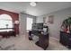 Office area with a dark desk, two computer screens, and neutral colored walls at 848 Wingthorn Rose Dr, Gastonia, NC 28056
