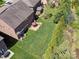 Aerial view of a home showcasing a well-maintained yard, patio set, and manicured landscaping at 9622 Harvest Pond Nw Dr, Concord, NC 28027