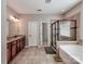 Full bathroom featuring double sinks, a tub and a stand-up shower at 9622 Harvest Pond Nw Dr, Concord, NC 28027