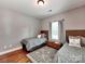 Charming bedroom with two twin beds, hardwood floors, and neutral decor at 9622 Harvest Pond Nw Dr, Concord, NC 28027