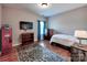 Charming bedroom featuring a sporty locker, hardwood floors, and a large area rug at 9622 Harvest Pond Nw Dr, Concord, NC 28027