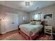 Inviting bedroom with hardwood floors, a comfortable bed, and a decorative chandelier light at 9622 Harvest Pond Nw Dr, Concord, NC 28027