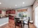 Cozy dining area featuring a round wooden table, wood flooring, and a window for natural light at 9622 Harvest Pond Nw Dr, Concord, NC 28027