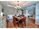 Elegant dining room showcasing hardwood floors, a chandelier, and decorative wall trim at 9622 Harvest Pond Nw Dr, Concord, NC 28027