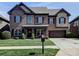 Charming two-story brick home with a well-manicured lawn, attached garage, and inviting front porch at 9622 Harvest Pond Nw Dr, Concord, NC 28027