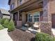 Cozy front porch with chairs, perfect for relaxing, framed by brick pillars and manicured landscaping at 9622 Harvest Pond Nw Dr, Concord, NC 28027