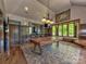 Spacious game room featuring a pool table, bar area, and ample natural light at 9622 Harvest Pond Nw Dr, Concord, NC 28027