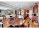 Spacious kitchen and dining area with dark wood cabinets, stainless steel appliances, and hardwood floors at 9622 Harvest Pond Nw Dr, Concord, NC 28027