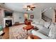 Spacious living room with a cozy fireplace, hardwood floors, and comfortable seating at 9622 Harvest Pond Nw Dr, Concord, NC 28027