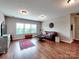 Bright living room with hardwood floors, rug, and large windows at 9622 Harvest Pond Nw Dr, Concord, NC 28027