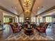 Elegant living room with vaulted ceilings, a stone fireplace, hardwood floors, and ample seating at 9622 Harvest Pond Nw Dr, Concord, NC 28027