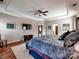 Cozy main bedroom offering a tray ceiling and hardwood floors at 9622 Harvest Pond Nw Dr, Concord, NC 28027