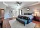 Comfortable main bedroom featuring a tray ceiling and hardwood floors at 9622 Harvest Pond Nw Dr, Concord, NC 28027