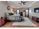 Lovely main bedroom boasts a tray ceiling and hardwood floors at 9622 Harvest Pond Nw Dr, Concord, NC 28027