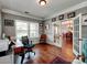 Well-lit office with hardwood floors and French doors, ideal for a productive work environment at 9622 Harvest Pond Nw Dr, Concord, NC 28027
