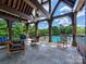 Community poolside patio with comfortable seating, ceiling fans, and beautiful views at 9622 Harvest Pond Nw Dr, Concord, NC 28027